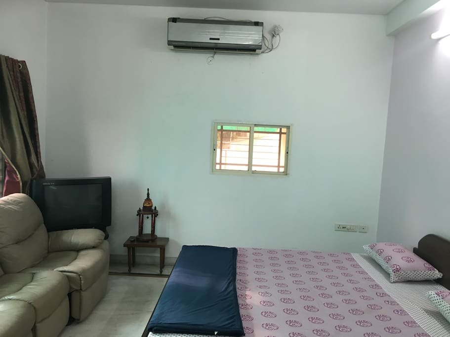 Air Conditioner on the wall next to the bed