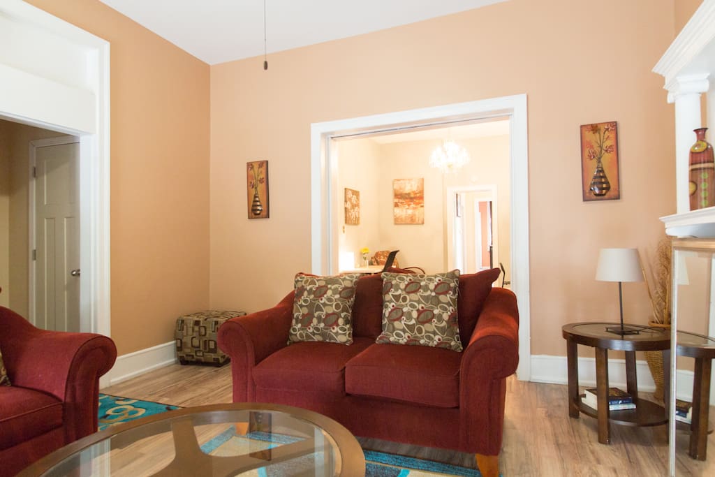Comfy living room with queen size sofa sleeper flows right into the sitting room with queen sized futon and table that's perfect for card and board games.