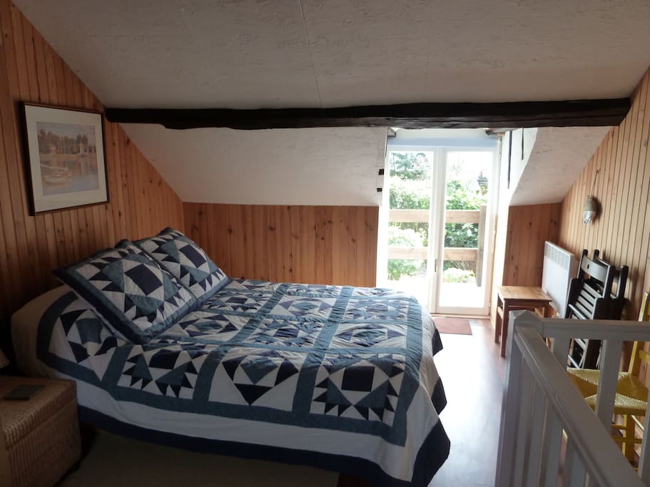 Double bedroom looking out on to balcony and garden