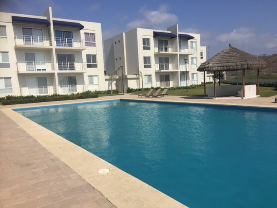 Pool facing the ocean with bbq area.