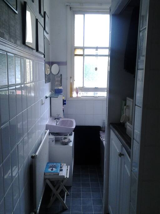 Bathroom with shower over bath. WC in a separate room.
