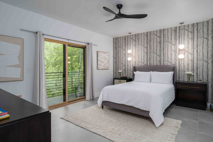 Bedroom 2 featuring private balcony and en suite bathroom with walk in shower