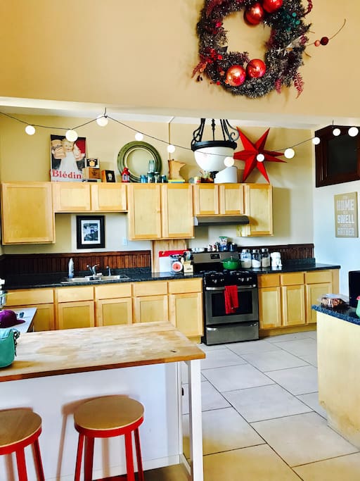 The kitchen is fully stocked with pots, pans, plates, and glassware, along with cooking basics such as spices, salt, oil, etc.