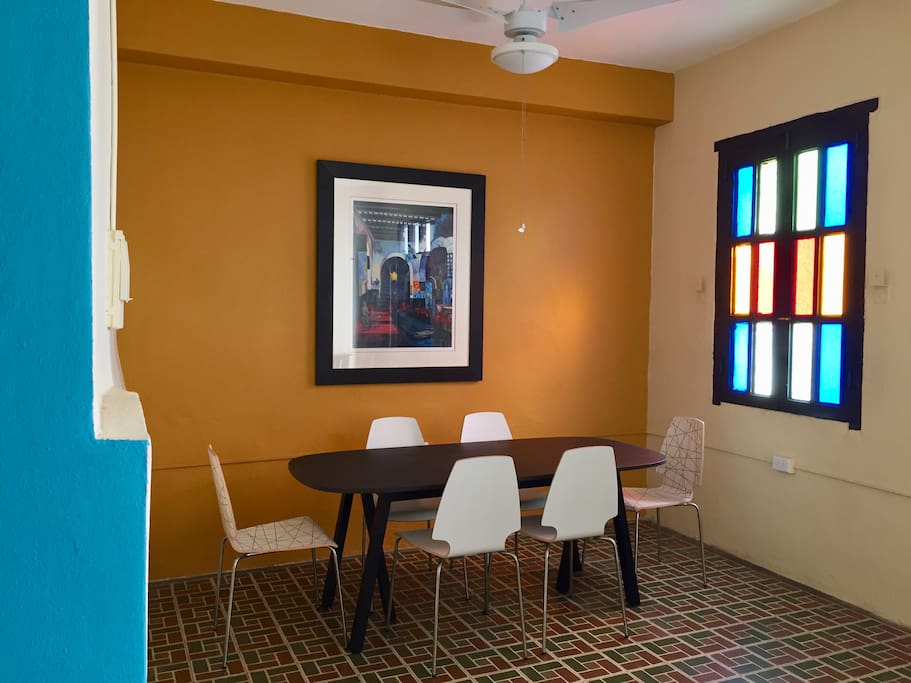 Dining table with 6 chairs. The window opens to Cathedral of San Juan Bautista (1521).