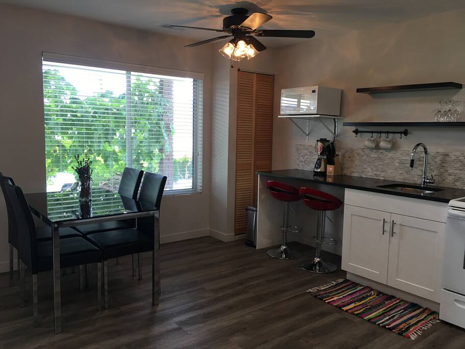 Eating area in kitchen with large bright window. Grape vines and lake view