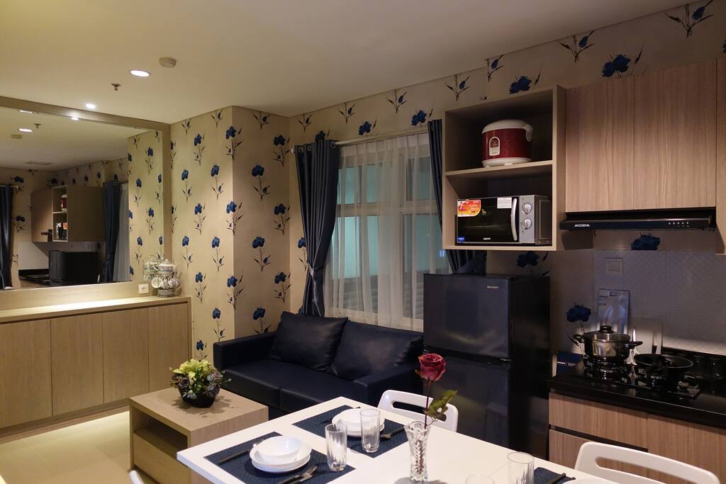 Living Area equipped with comfortable sofa, TV, Air Conditioning and Coffee Table.