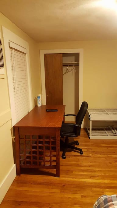 Large desk with comfortable desk chair. Closet for hanging belongings.