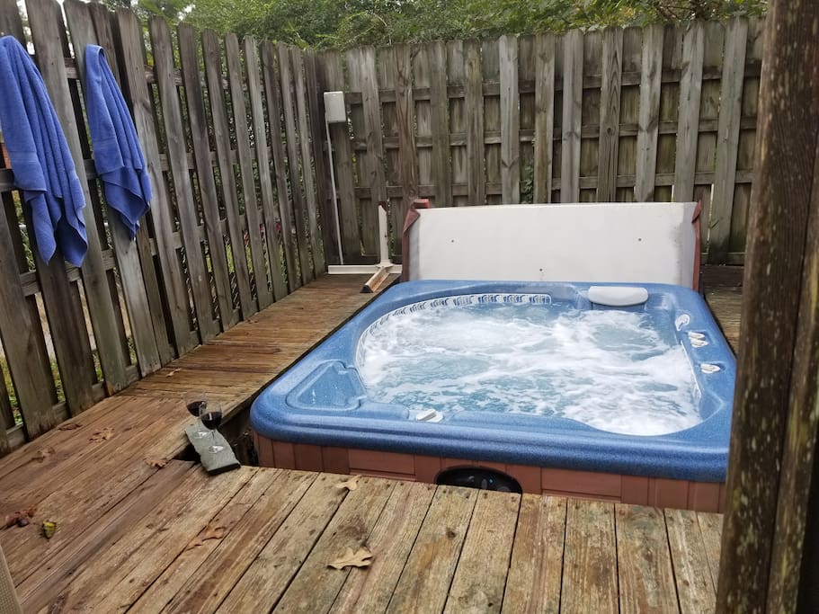 Relax and unwind in the private enclosed hot tub.