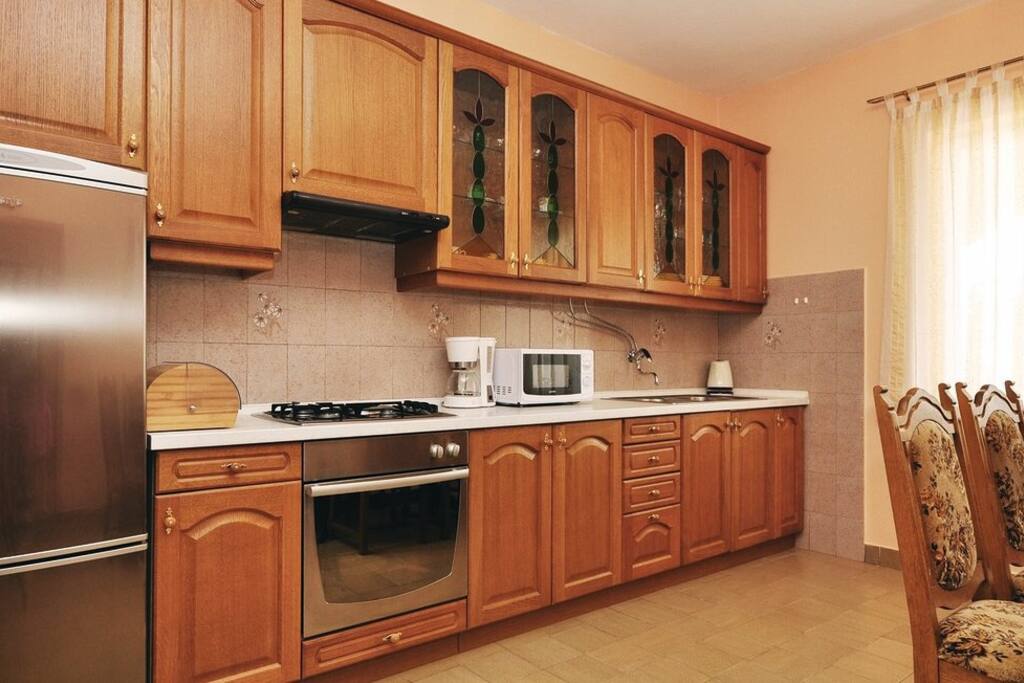 A spacious kitchen with microwave, coffee maker, electric kettle.