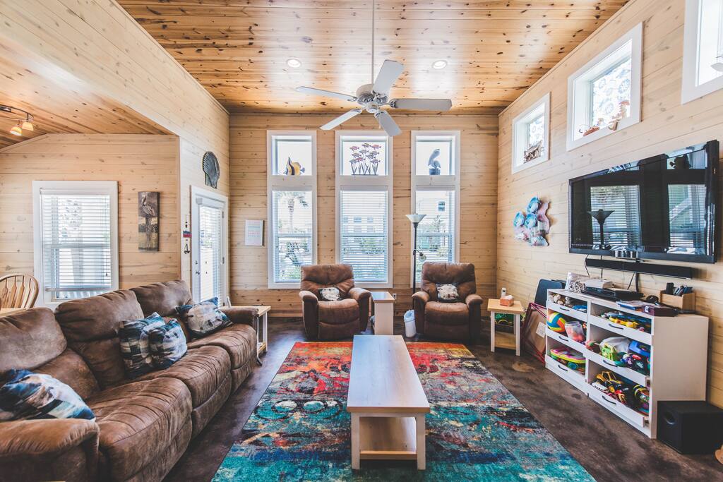 Our living room with two couches and recliners to relax after a day fishing or at the beach.