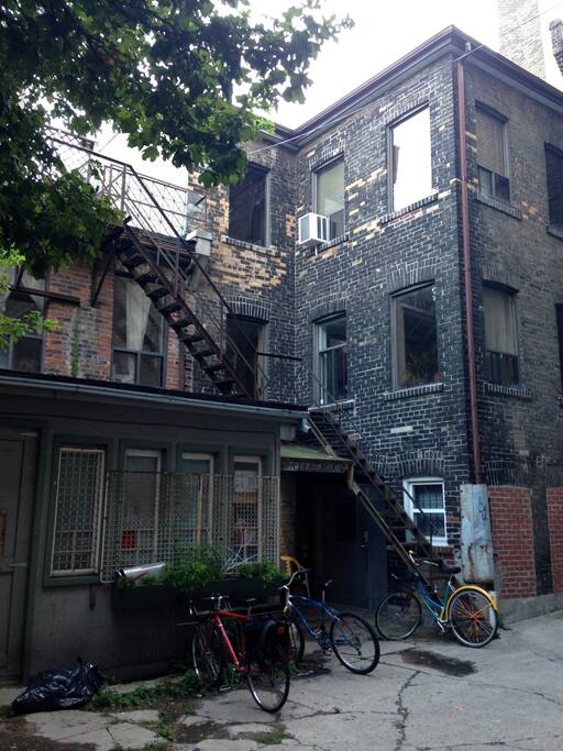 Exterior, inner courtyard where entrance to building is located with three bike racks for securing your bike.