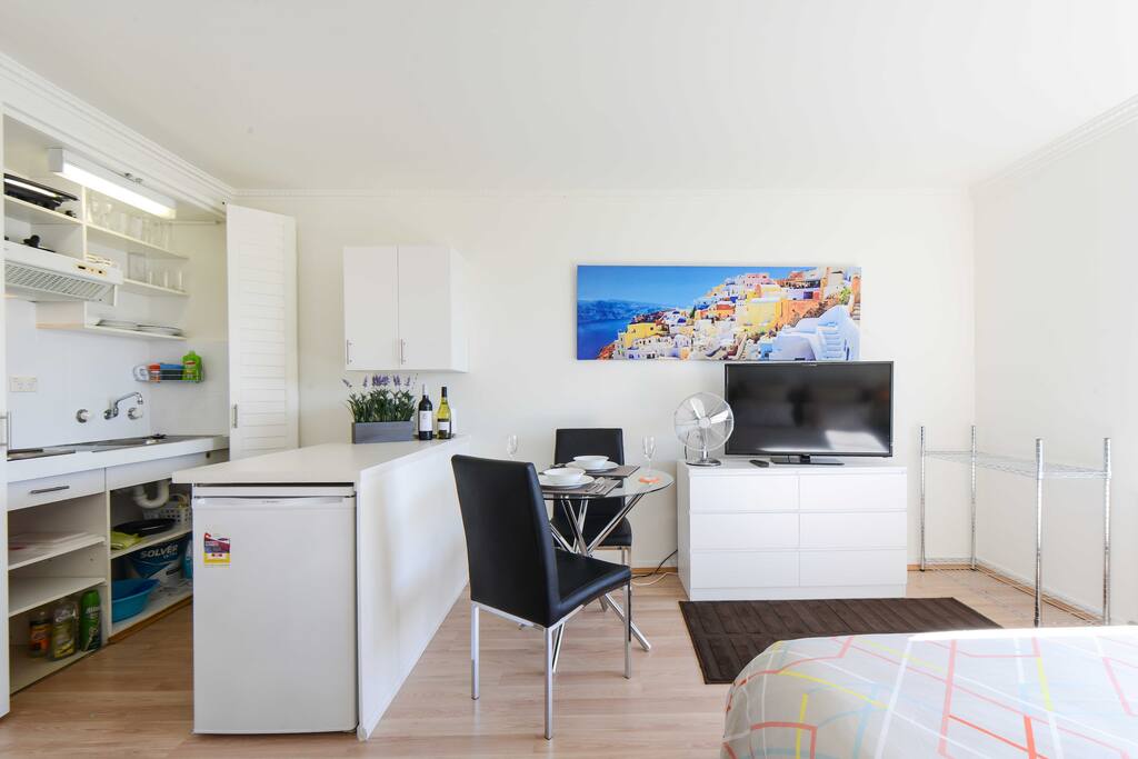 Cupboard kitchen, fridge, table and chairs, large TV and luggage stand