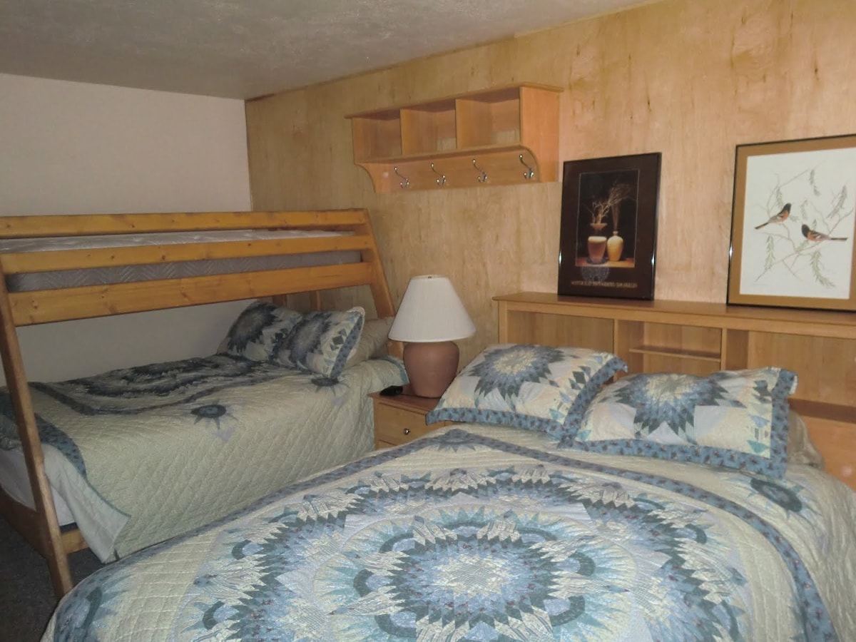 Second bedroom:  one queen, one double in bottom with twin on top bunk, private bathroom.  Smart TV.  Exterior door access on west side for ski locker, access to hot tub, firepit, outdoor grill with picnic area, and ski slopes.