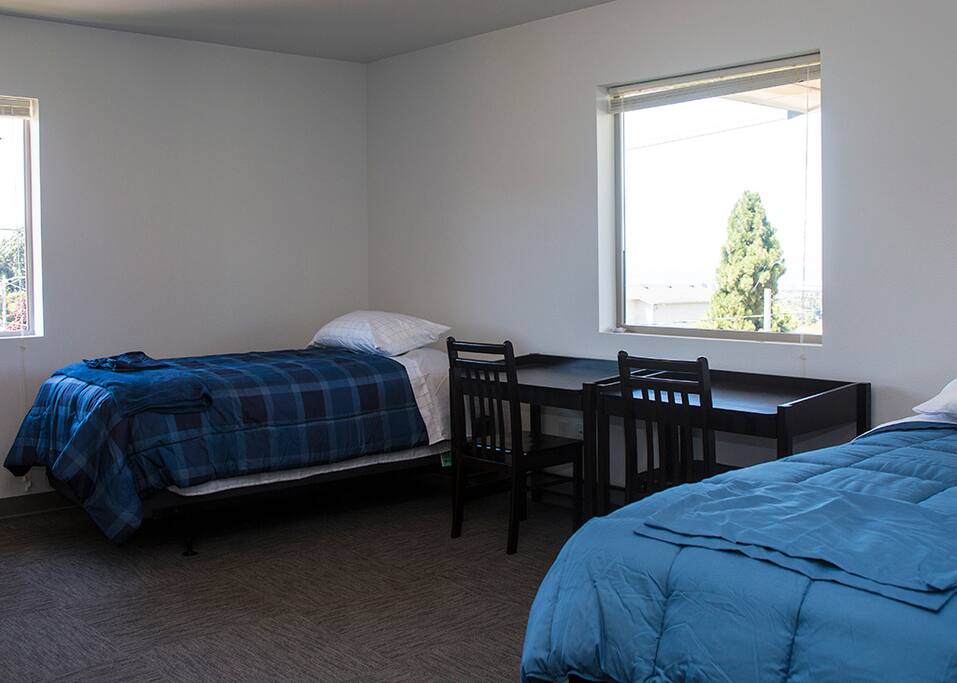 Bedroom with two beds and two windows