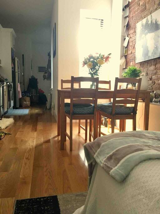 Dining room table and kitchen in the background.