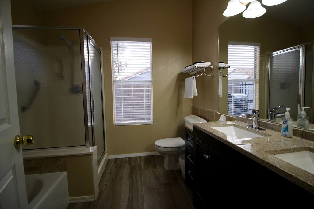 Private bathroom includes two sinks, a shower, and a bathtub.