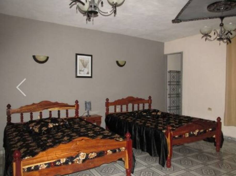 Private bedroom with 2 queen beds, equipped with AC and minibar.