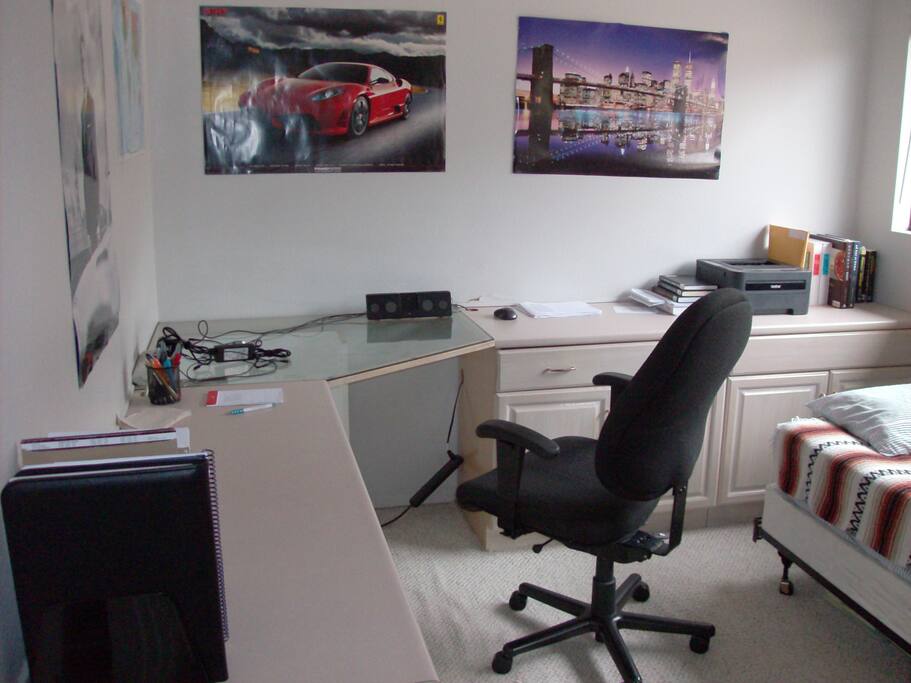 Work area in bedroom proximity to bed