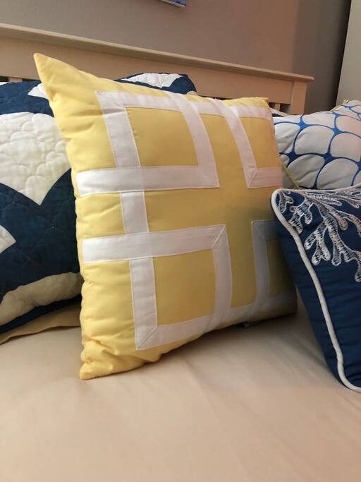 Luxurious feel with extra pillows in bright, welcoming colors.