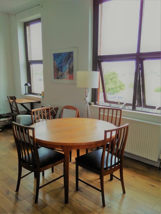 Table in living room with river view, seats 4 (but extends to seat up to 8)