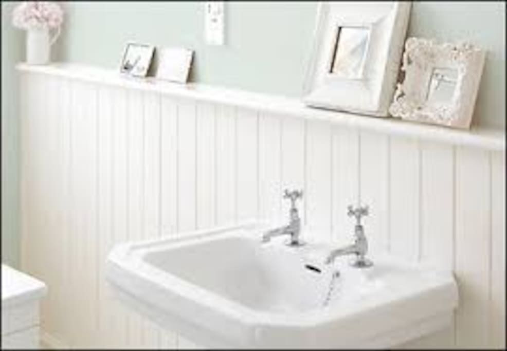 Tiled and panelled shower room.
