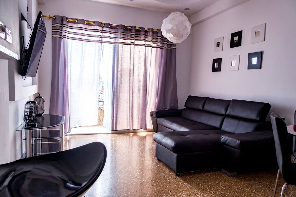 room with 55 "TV and balcony with beautiful views of the sea and the city
