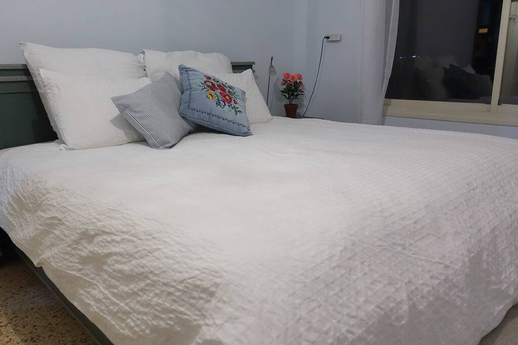 Plush king sized bed with mattress topper. Feather duvet and pillows