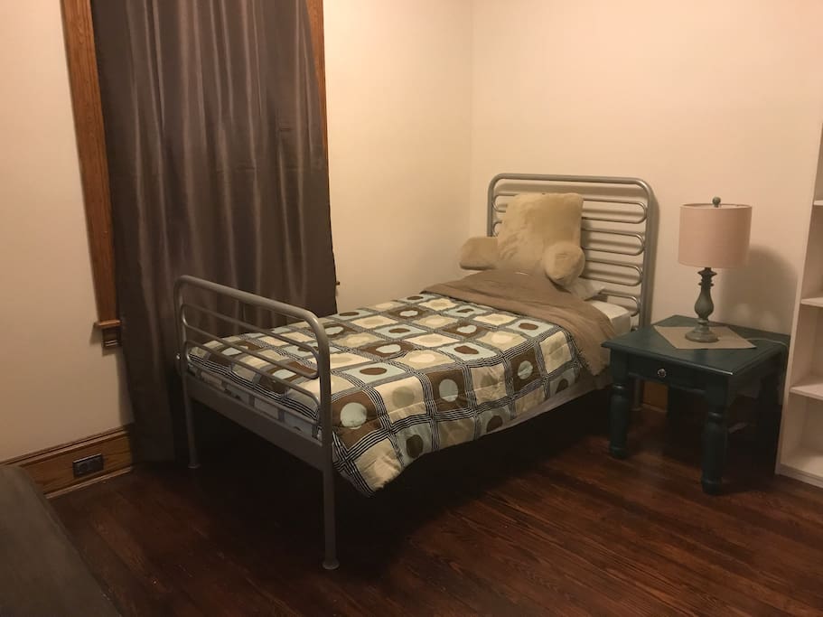 Single bed with a desk and chair.
