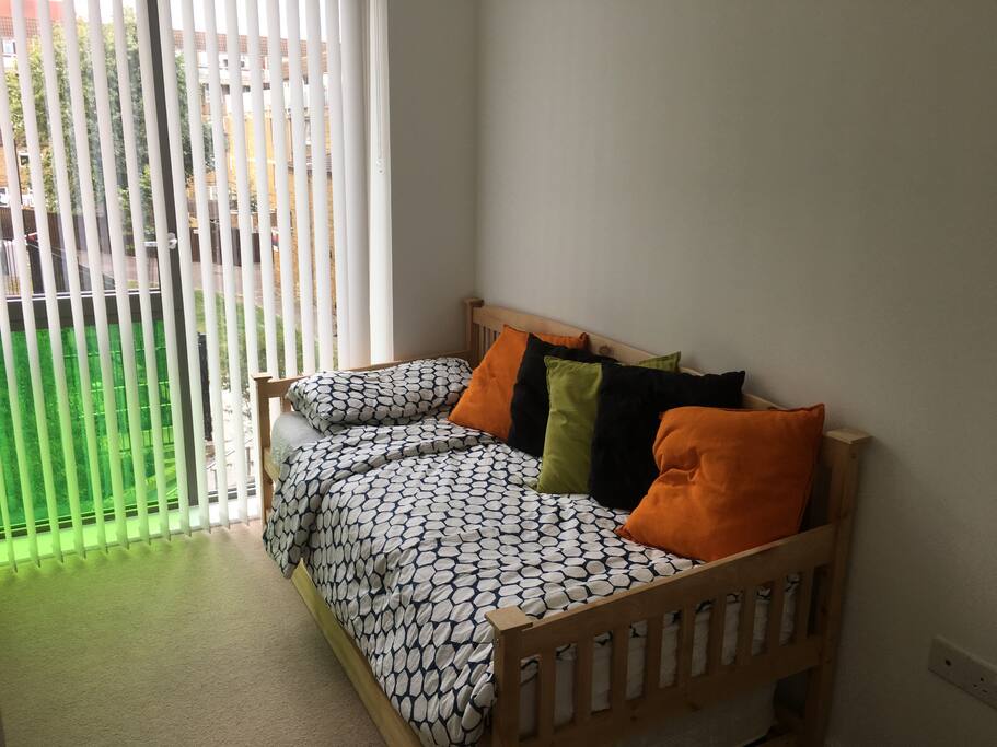 Single bed with another bed underneath it which creates a double bed.