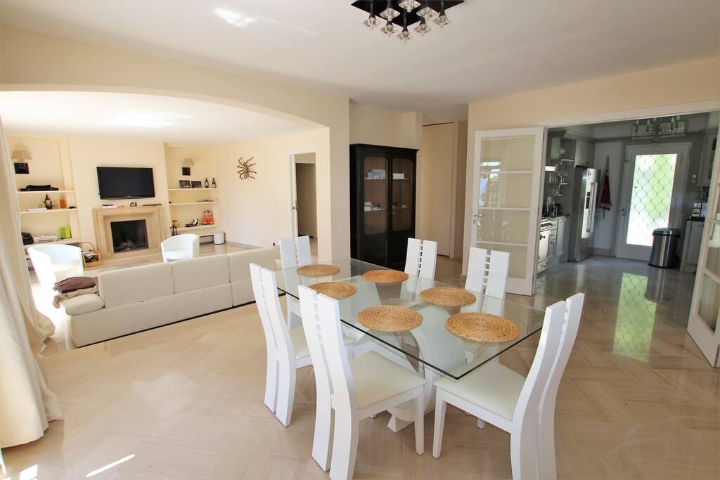 Large living room, dining area, all opening onto a terrace with sea view