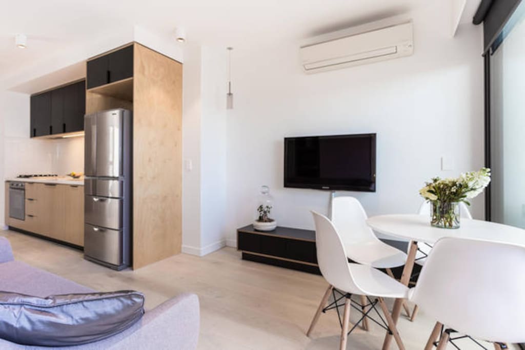 Open plan living with 42" TV and modern Sofa.