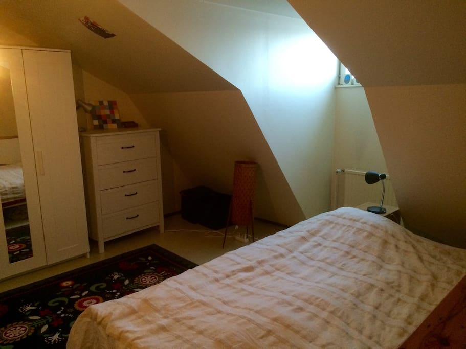 Bedroom. Lovely light from the roof window. Comfortable double bed. Also good, ergonomic working unit with table&chair.