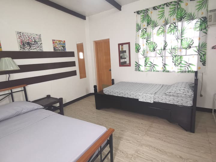 Room 2 has Double bed and a single bed with A/C and fan and T&B.