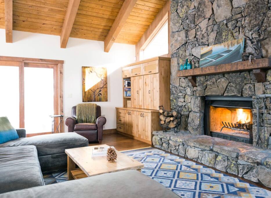 Living Room with large sectional, tall ceilings and fireplace for a welcoming and comfortable space to gather.