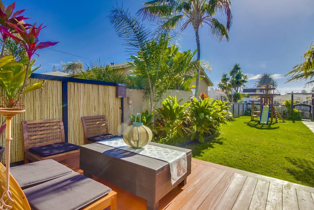 View of yard & play area. Lock box is on the fence to the left beneath mailbox.