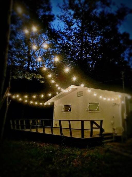 Enjoy evenings on the porch under the canopy of giant oak trees and Edison lights.