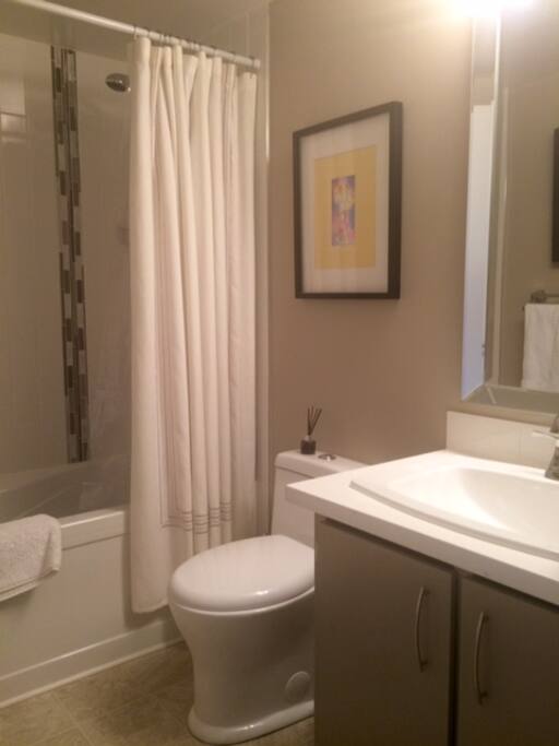 new bathroom with soaker tub, high quality linens and original art