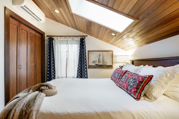 Cozy bedroom with queen bed and selection of down pillows. Overhead skylight has electronic blackout shade. There is plenty of closet space to unpack.