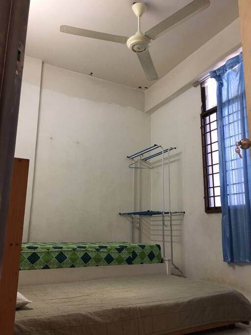 Small rm ~ cloth rack and ceiling fan.