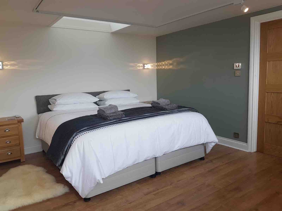 A super king size,  back care, individual comfort bed with 800 pocket springs for othorpaedic support, with a layer of British wool for warmth. Under bed draws on both sides. Ample space/light and high quality bedding. Blackout blinds to all windows.