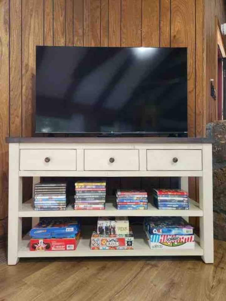 50 inch Roku TV in living room. DVD player, movies, board/card games, puzzles, coloring books and crayons.