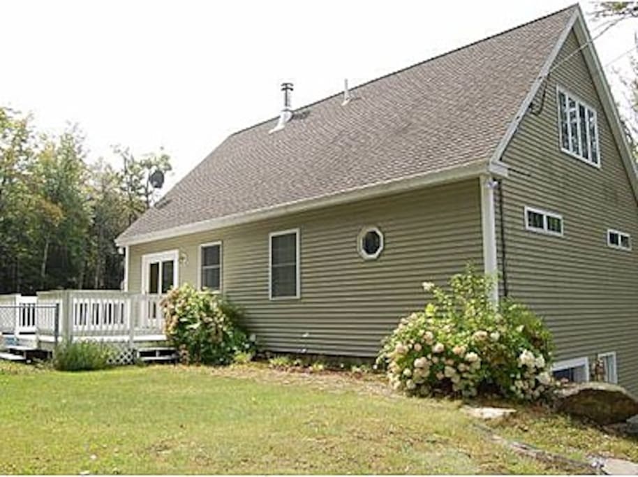 Back deck leads to large fenced in yard
