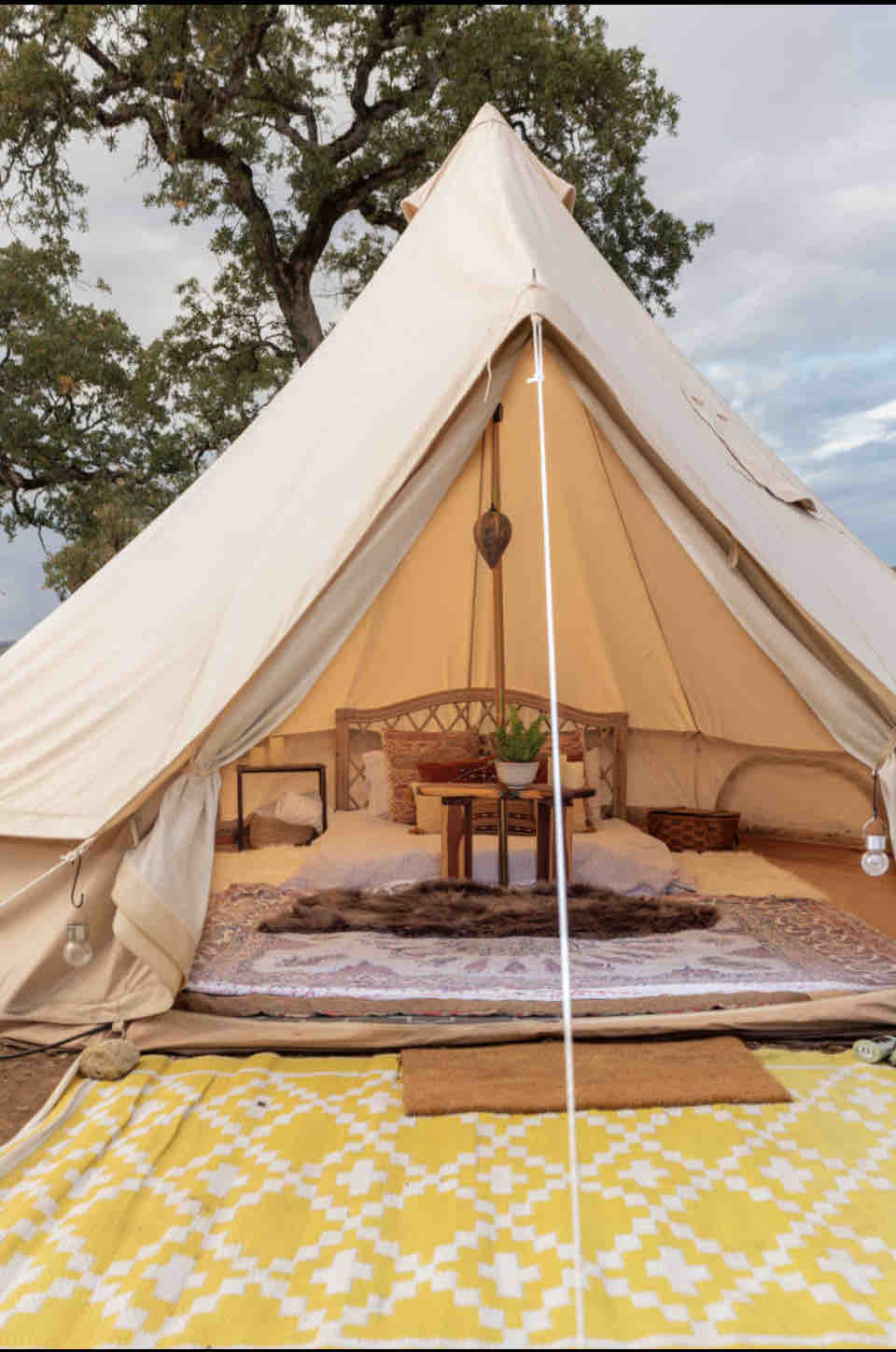 Candlelit romantic bohemian belle tent -- a top of the line cotton canvas Stout Professional 16 ft/5 meter with double layers of bug netting. Furnished with coconut coir carpeting,