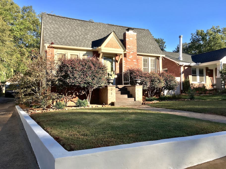 Architectural retaining wall frames the front yard.