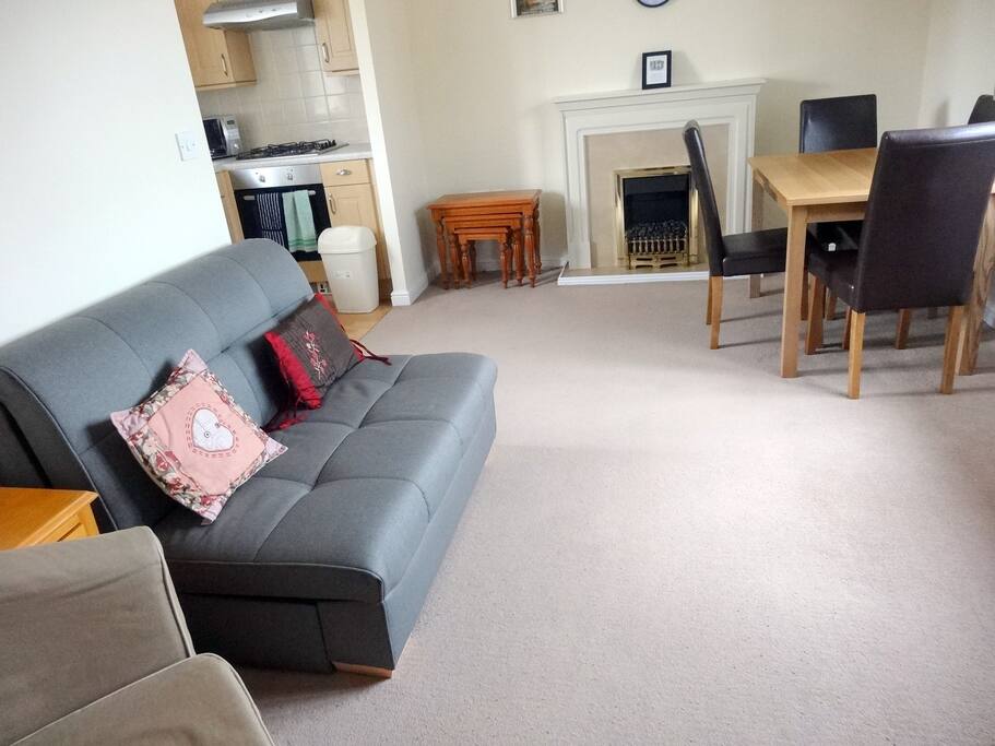 Lounge with fireplace, dining table, TV with CD player, small sofabed