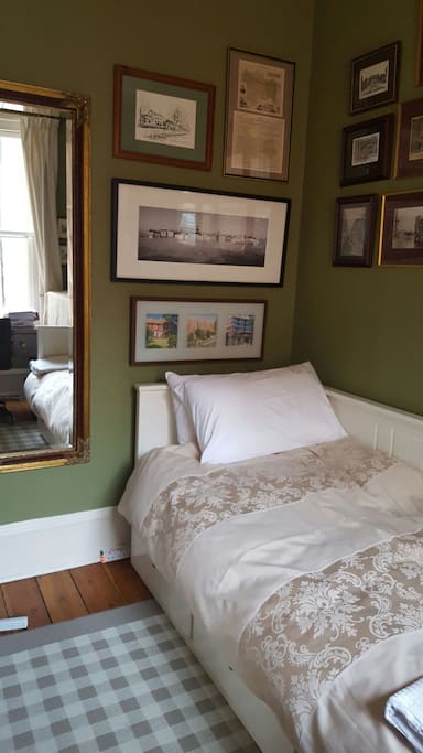 A cosy single bed is ready for you.