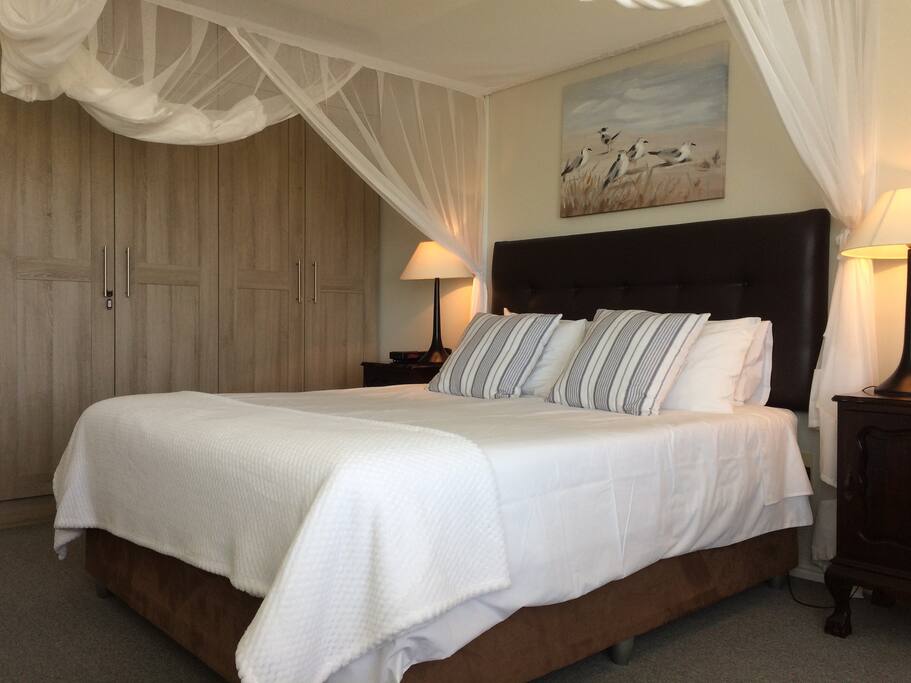 Main bedroom with queen size bed on first floor.