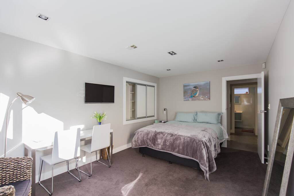 Comfortable queen bed and generous desk space