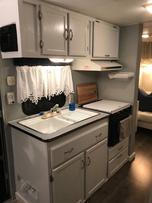 Kitchen with stove, microwave and refrigerator