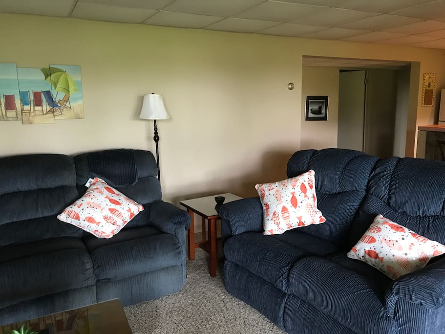 Living room with TV and sliding door entrance.